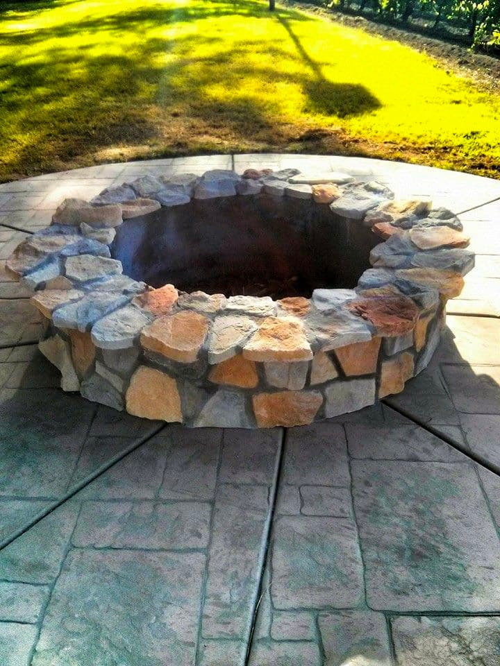 Concrete firepit area in a backyard