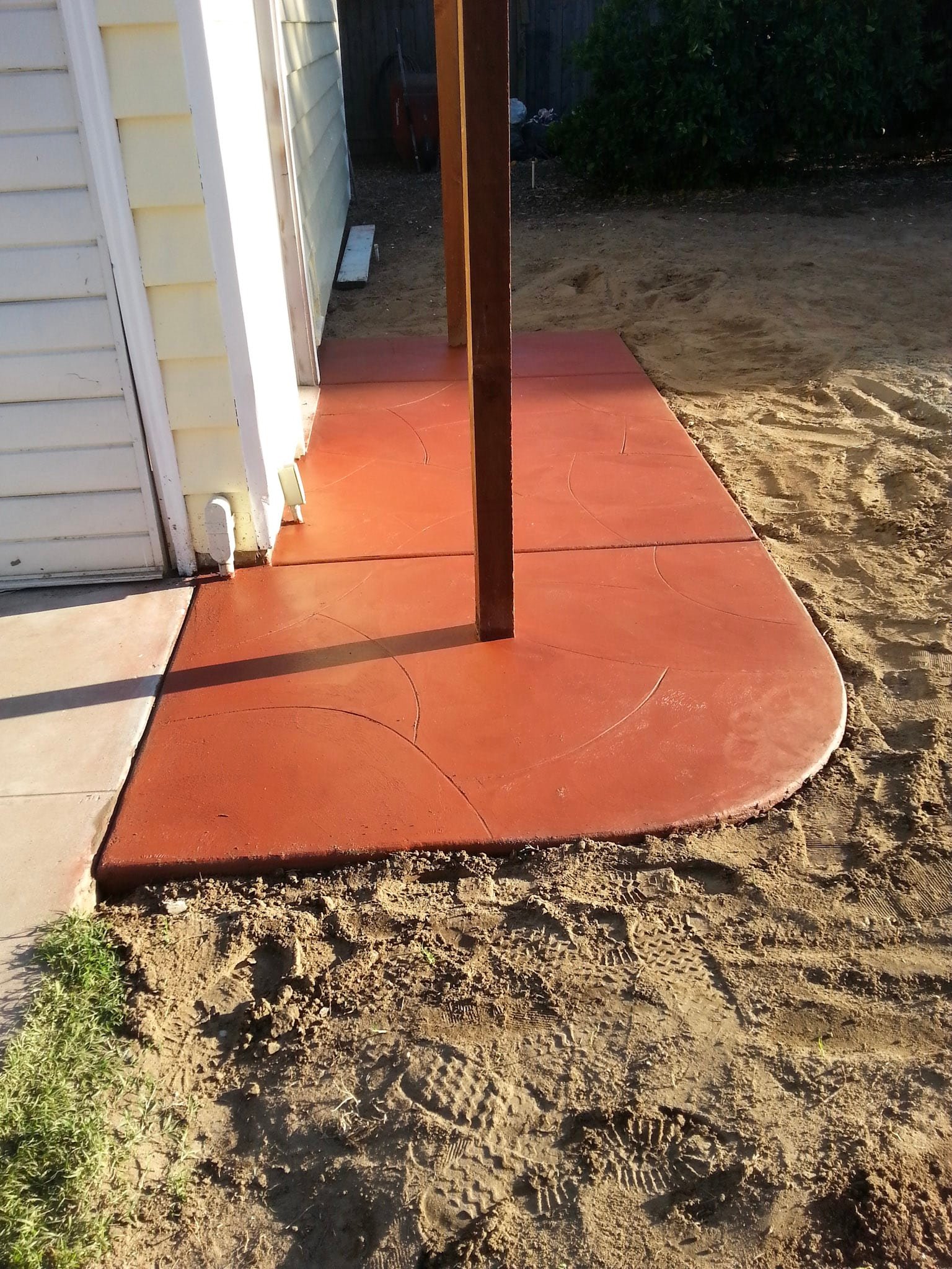 Concrete walkway through a front yard